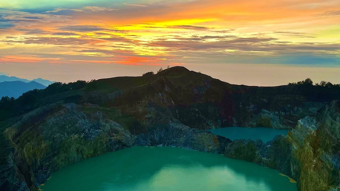 Kelimutu volcanic crater lakes glowing at sunrise, Flores Island, Indonesia